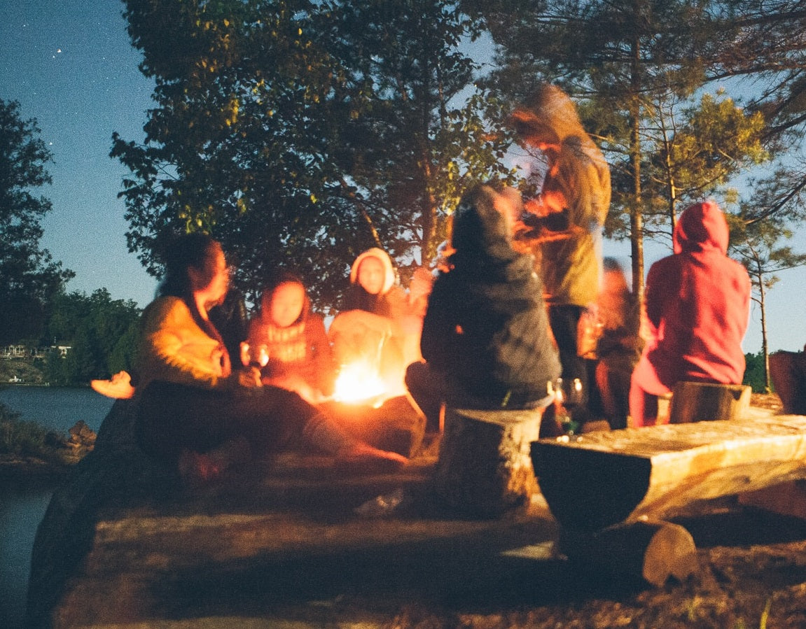 Group sitting around camp fire