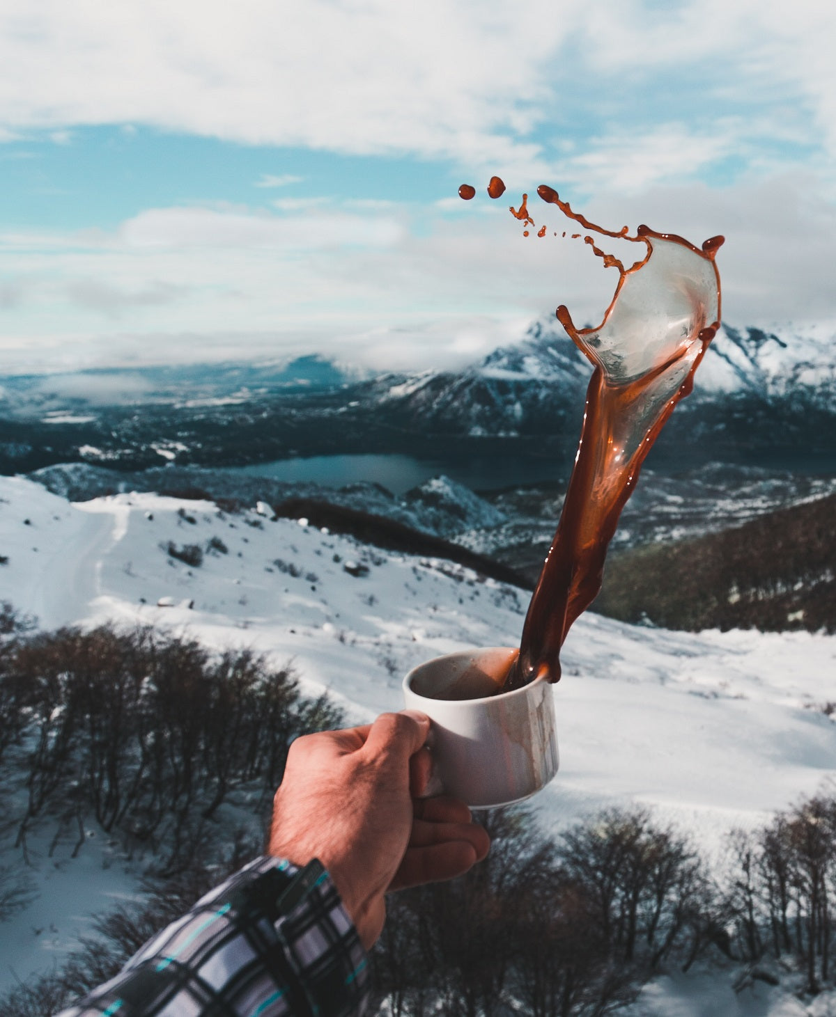 image tossing coffee with mountains in background