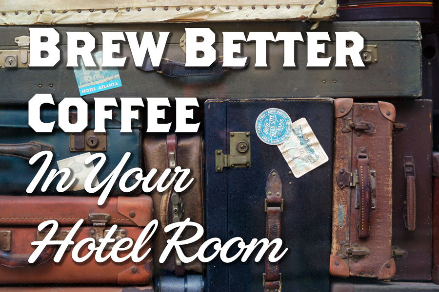 Vintage Suitcases are stacked in a neat pile, the words Brew Better Coffee in Your Hotel Room are overlas