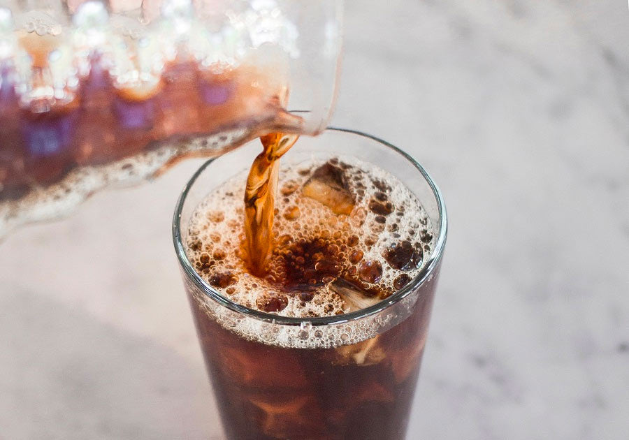 pouring cold brew into a cup