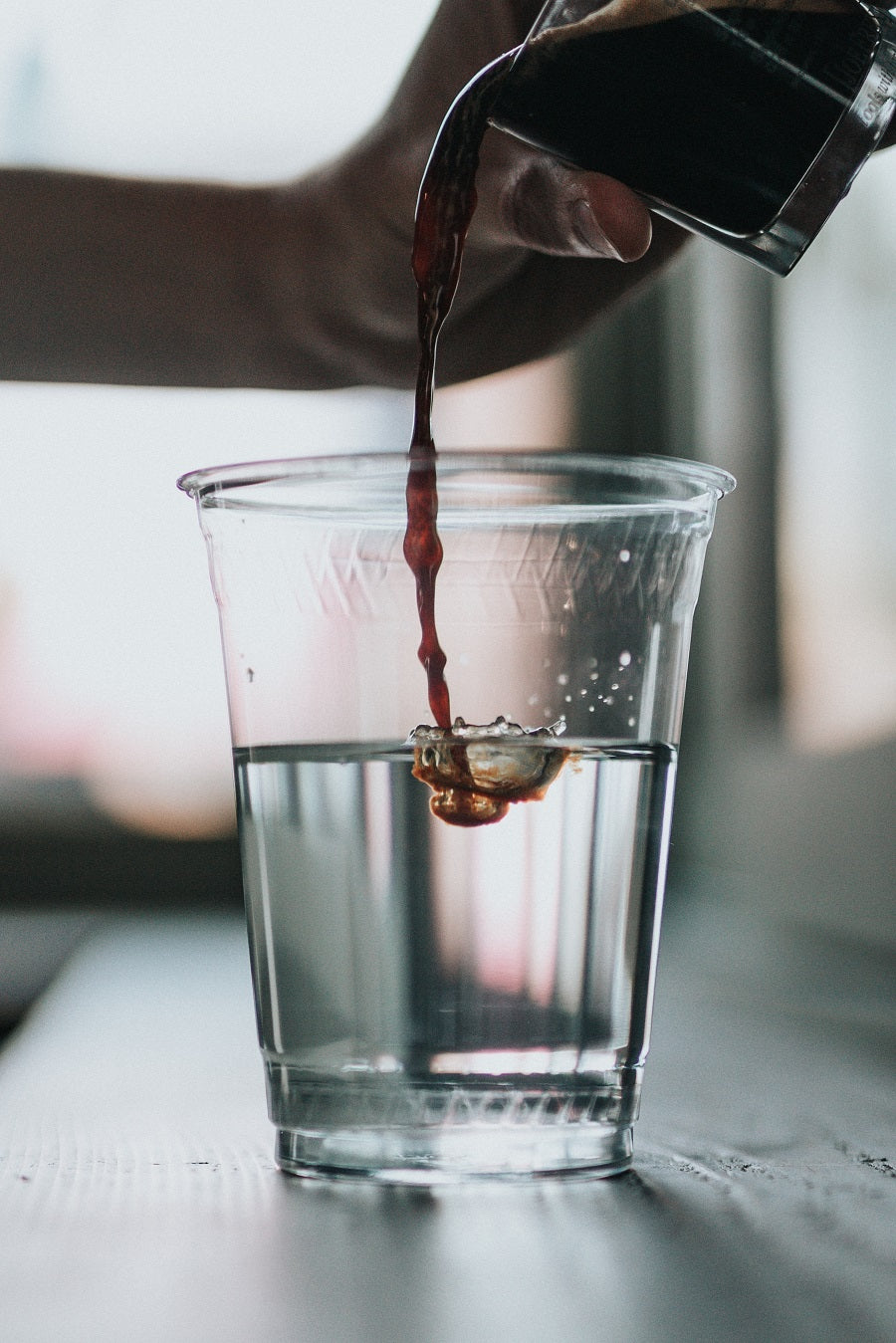 Toddy concentrate dumped into a glass of water