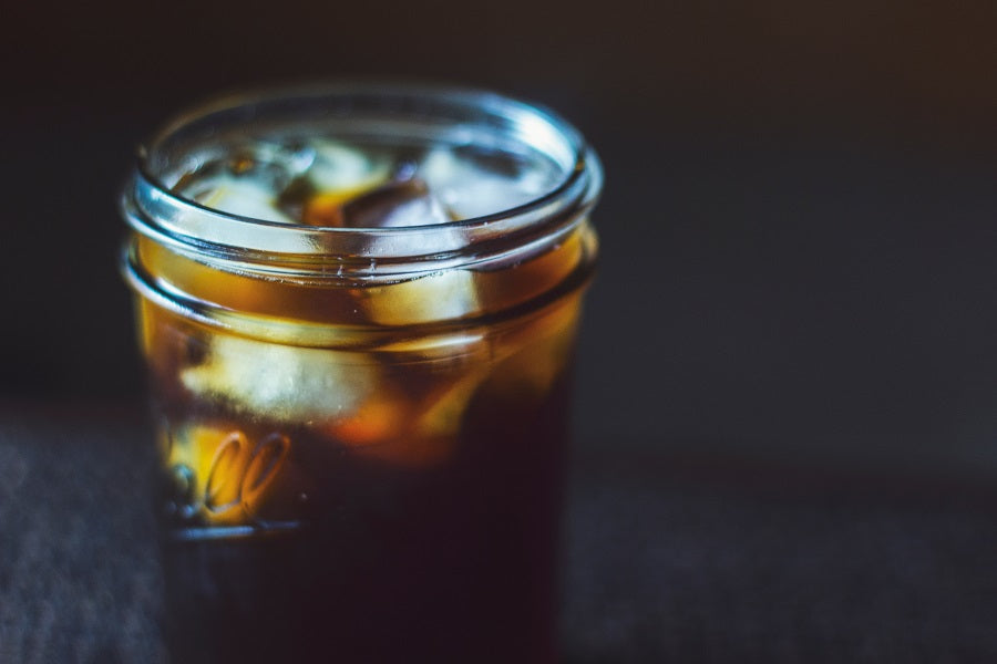 a close-up of a mason jar full of iced Toddy