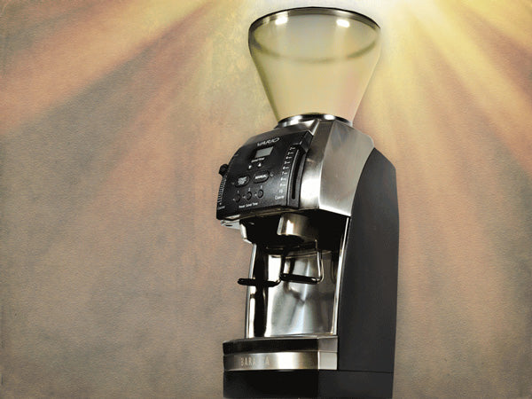 dramatic beams of light illumiate a Baratza Vario burr grinder