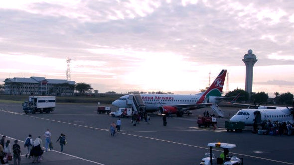 a view of the airstrip of the Kenya airport with a Kenya Airways plane waiting takeoff