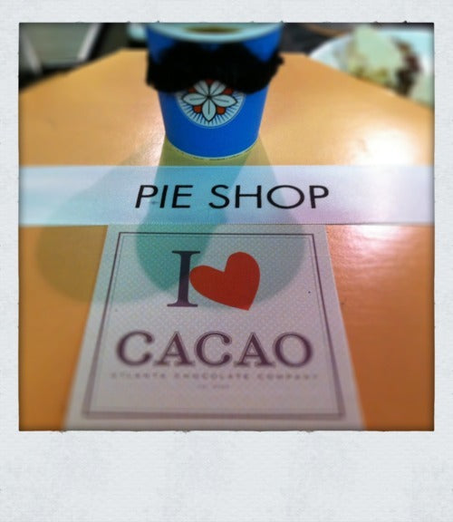 a blue batdorf branded cup sits alongside stickers from Cacao Atl and Pie Shop