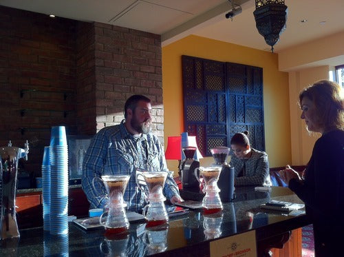 looking down the bar, baristas on the left, and attendees on the right line its length