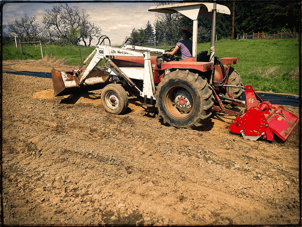 Tractor Tiller tills coffee chaff into soil